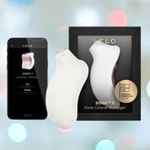 A LELO Sona 3 - Cream by LELO is displayed beside its black box and a smartphone featuring the LELO app, set against a softly blurred background with blue and pink lights.
